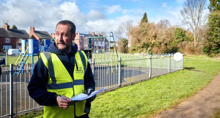 Community building manager surveying a community asset