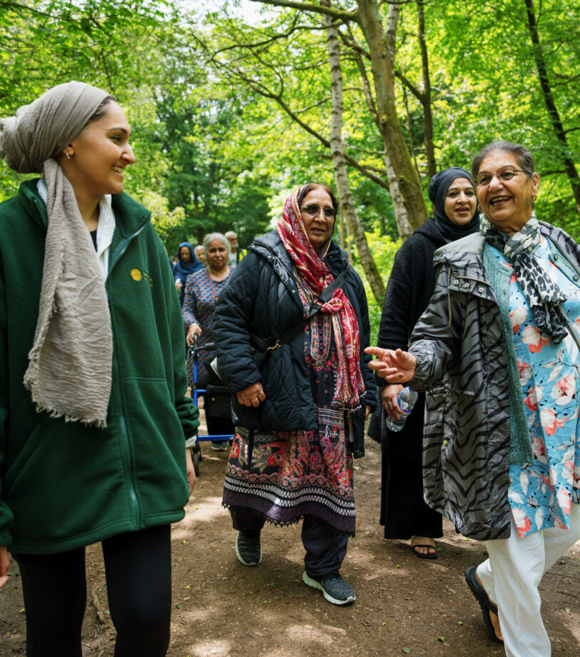 A walk in a green space with a diverse group of older people